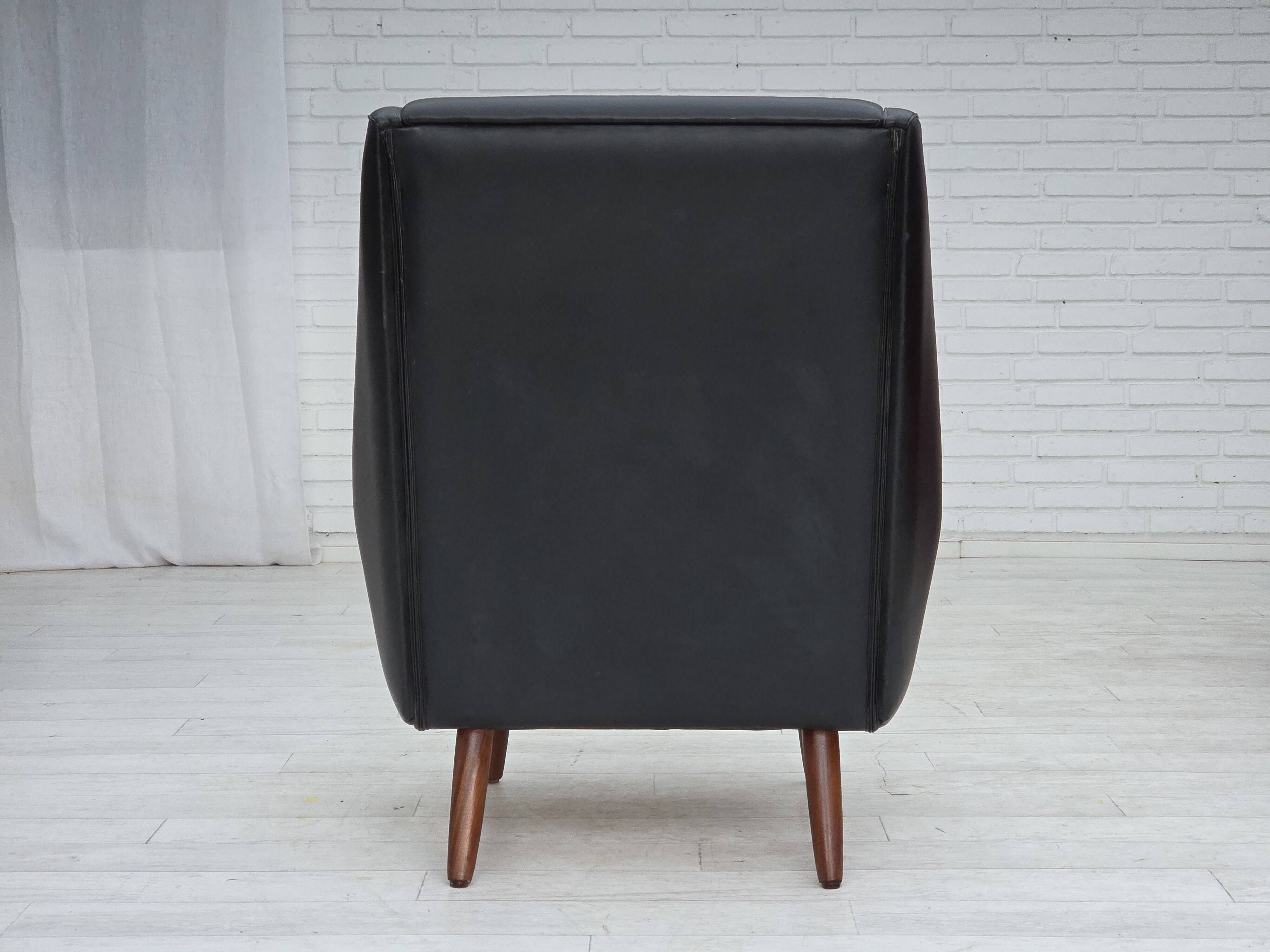 1970s, Danish highback armchair, black artificial leather, teak wood legs.
