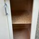 Vintage wall-mounted kitchen cabinet with sliding doors in 1960s retro style.