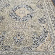 Large Persian wool rug 250x350 cm in gold and navy blue.