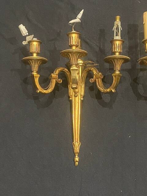 Pair of gilt bronze wall sconces with three lights in the Louis XVI style.