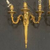 Pair of gilt bronze wall sconces with three lights in the Louis XVI style.
