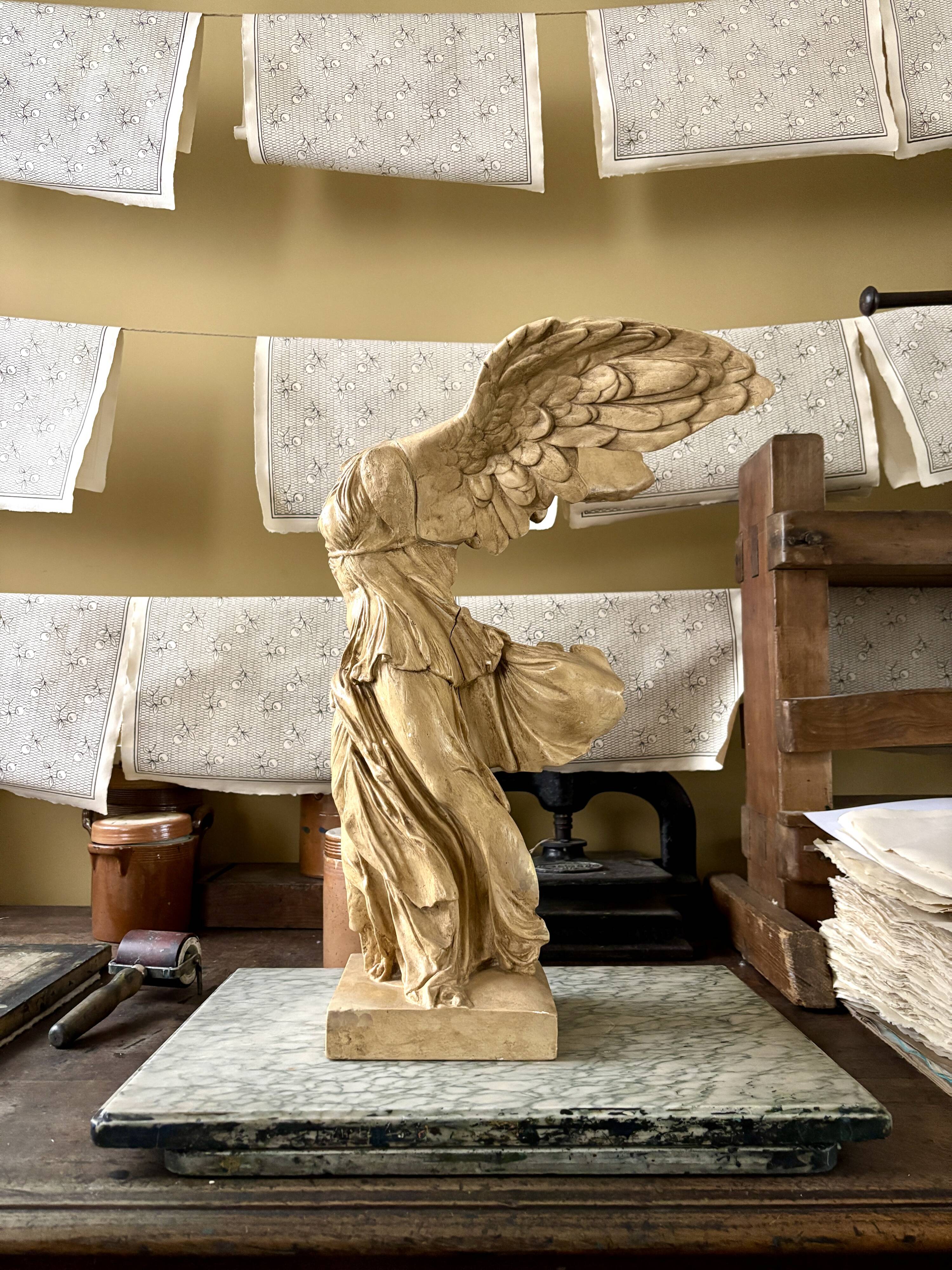 "Winged Victory of Samothrace", beige plaster statuette