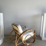 Large rattan rest chair and white cushions