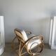 Large rattan rest chair and white cushions
