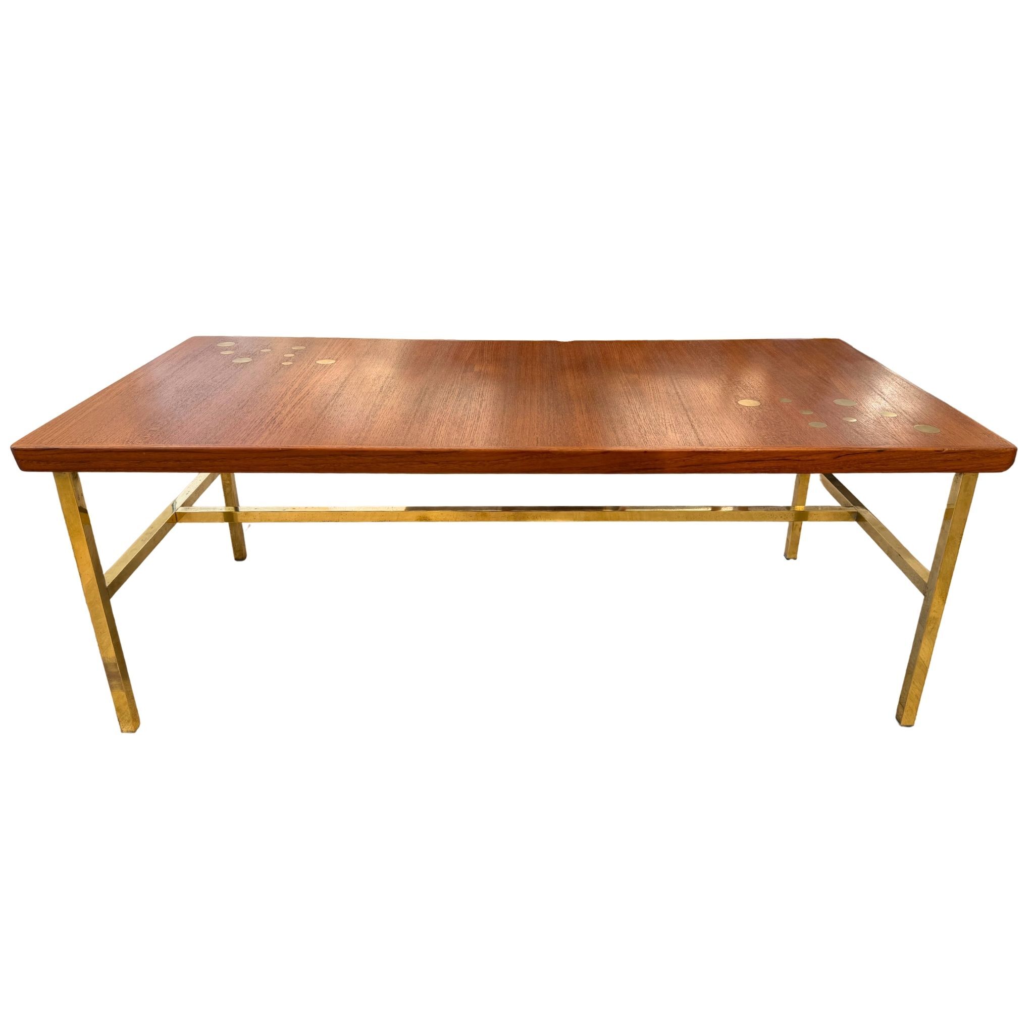 Scandinavian coffee table in teak and brass.