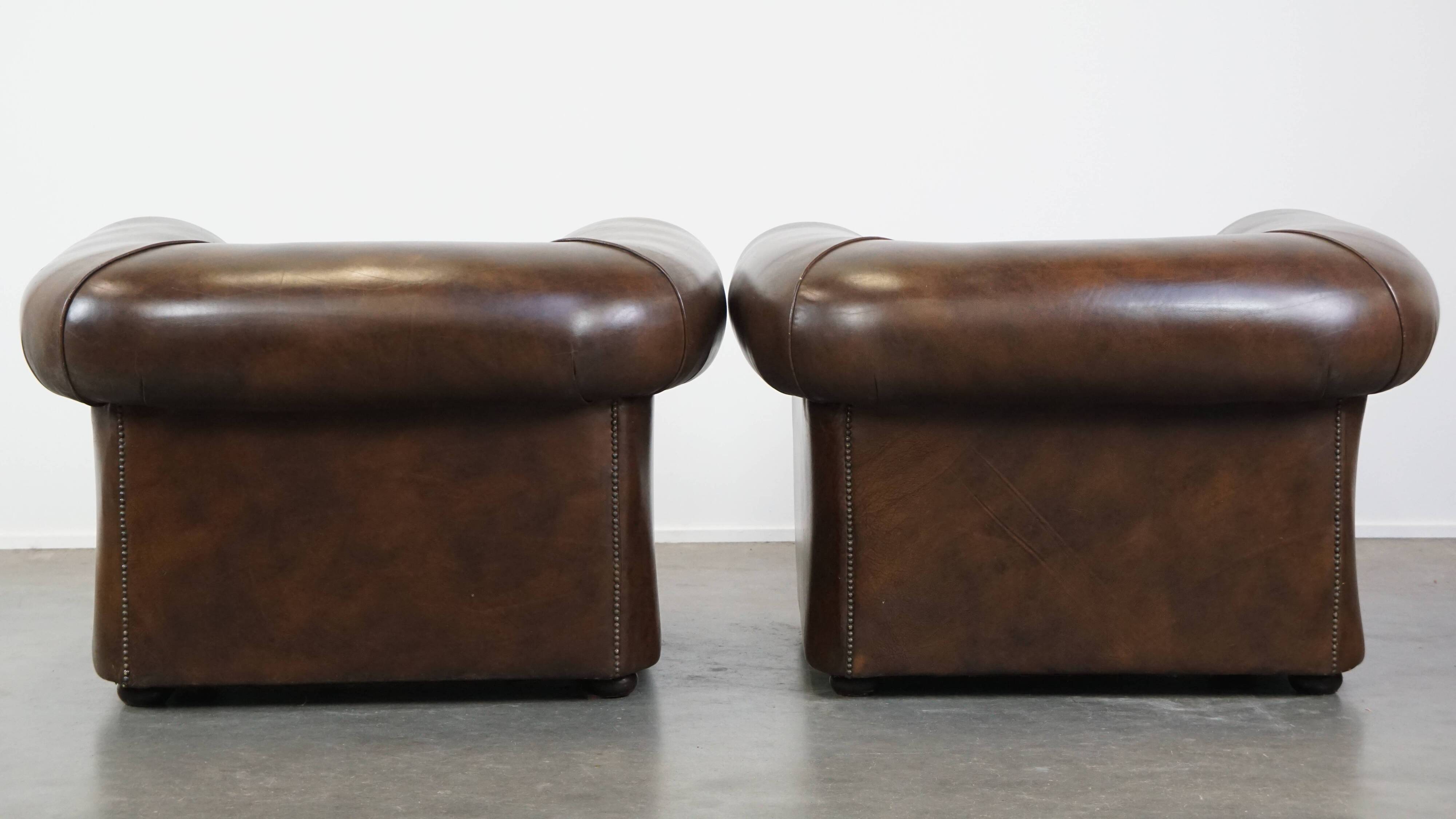2 Chesterfield armchairs in dark brown cowhide