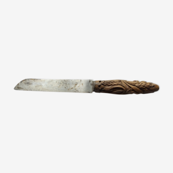 Old bread knife with a carved wooden handle