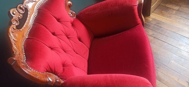 Baroque style carved wooden armchair in burgundy red velvet