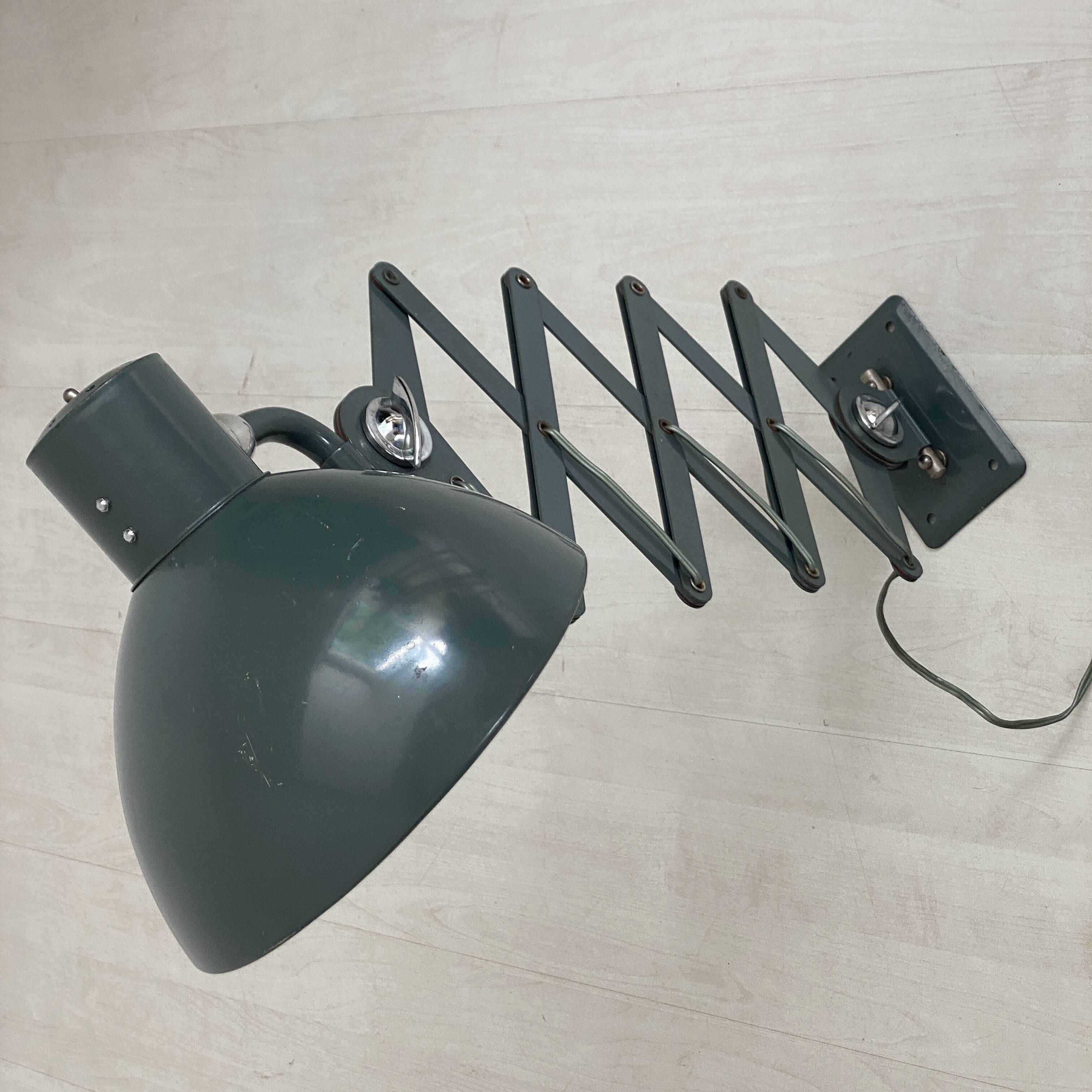 Vintage 1950s green lacquered sheet metal workshop wall light with accordion arm.