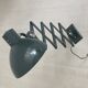 Vintage 1950s green lacquered sheet metal workshop wall light with accordion arm.