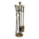 Neoclassical brass fire accessory.