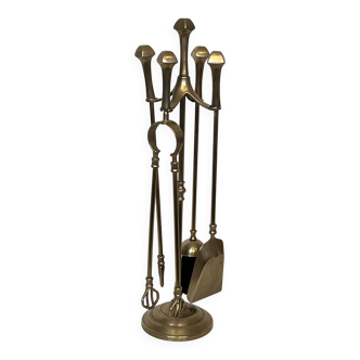 Neoclassical brass fire accessory.