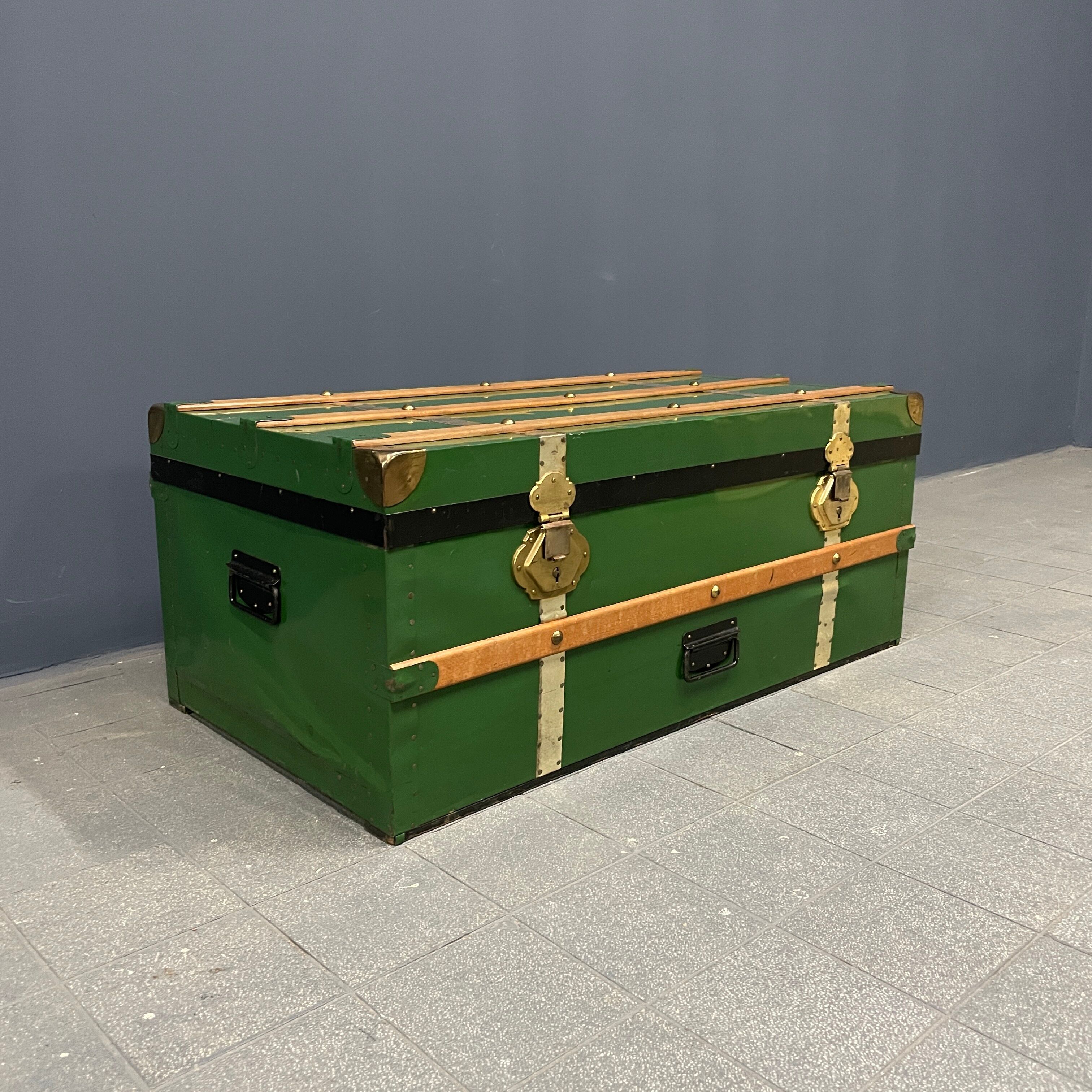 Green metal trunk with wooden sleds