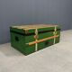 Green metal trunk with wooden sleds