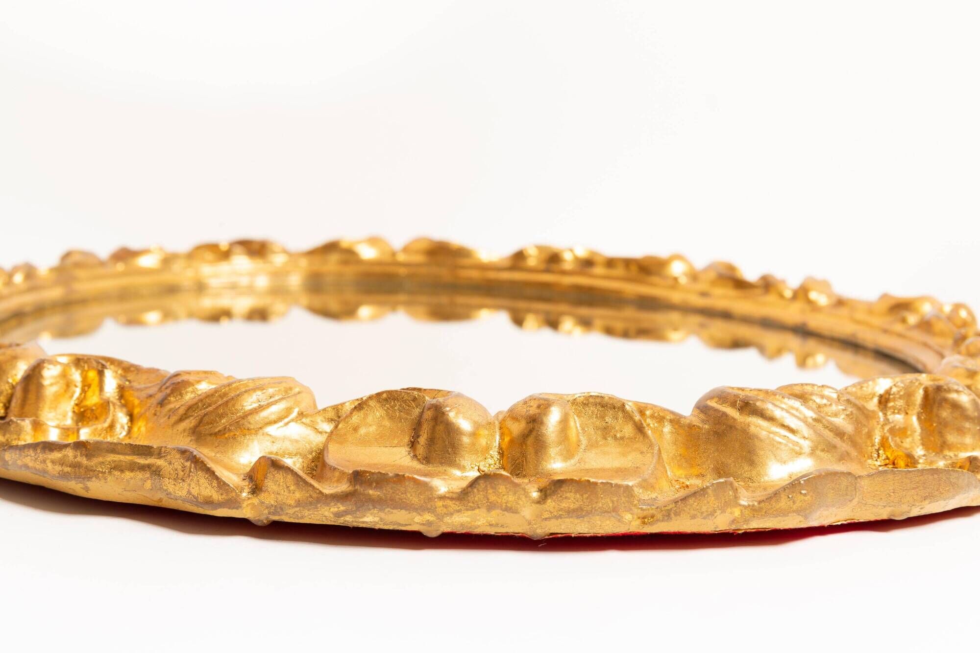 Vintage oval decorative mirror in gilded wood with floral frame, Italy, 1960s.