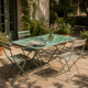 Bistro tables and folding chairs with a patina from the original 1930s.