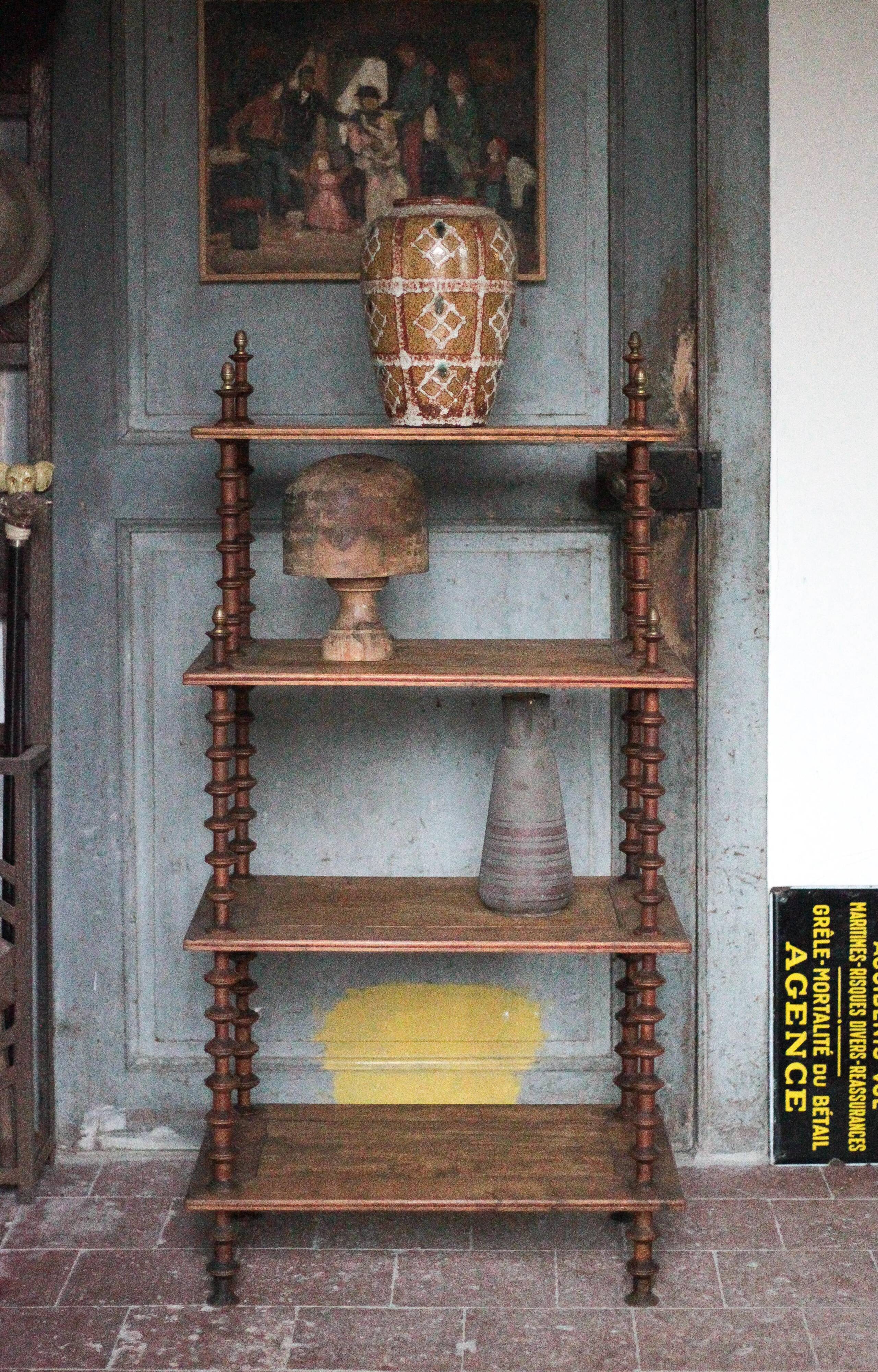 Napoleon III spool shelf, floor-standing shelf with brass tips.