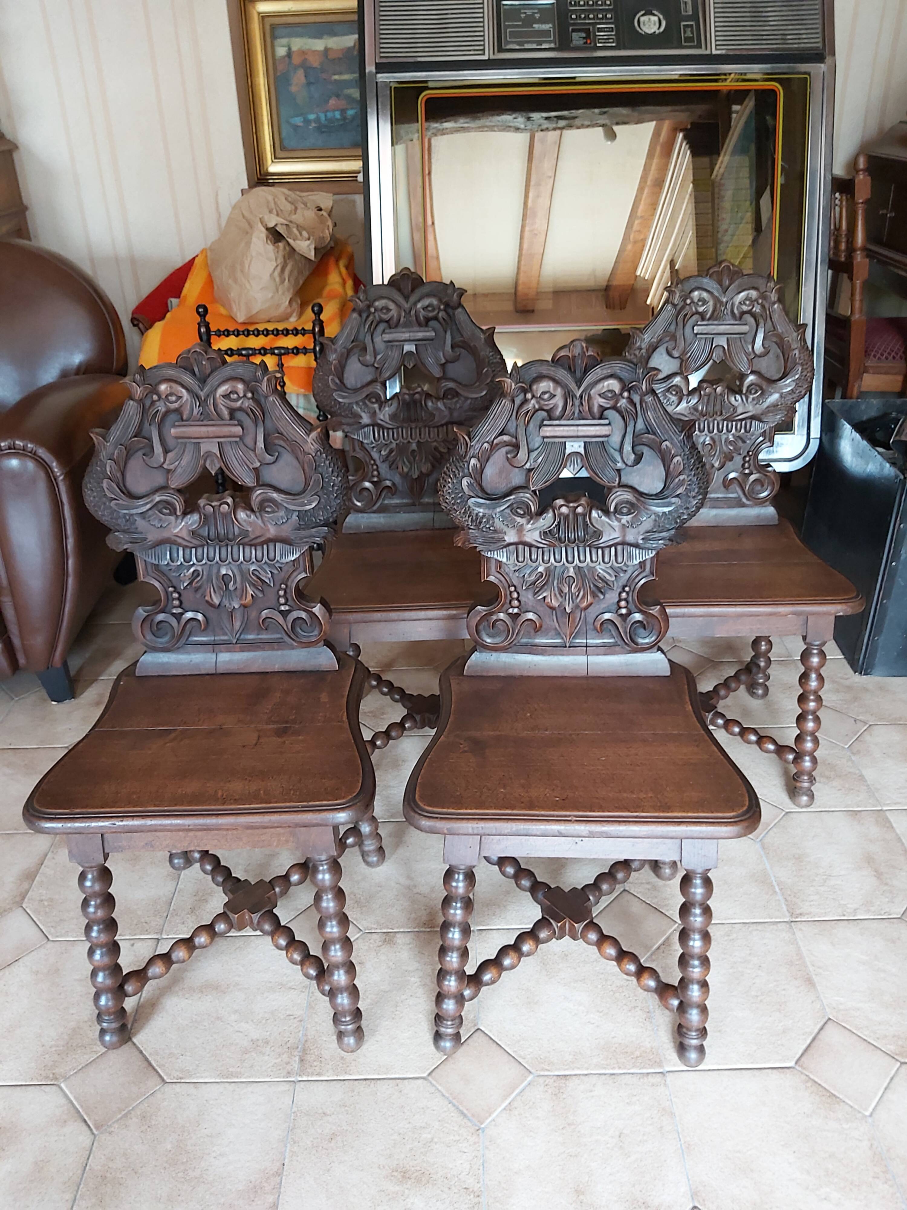 4 stylized dolphin back chairs