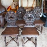 4 stylized dolphin back chairs