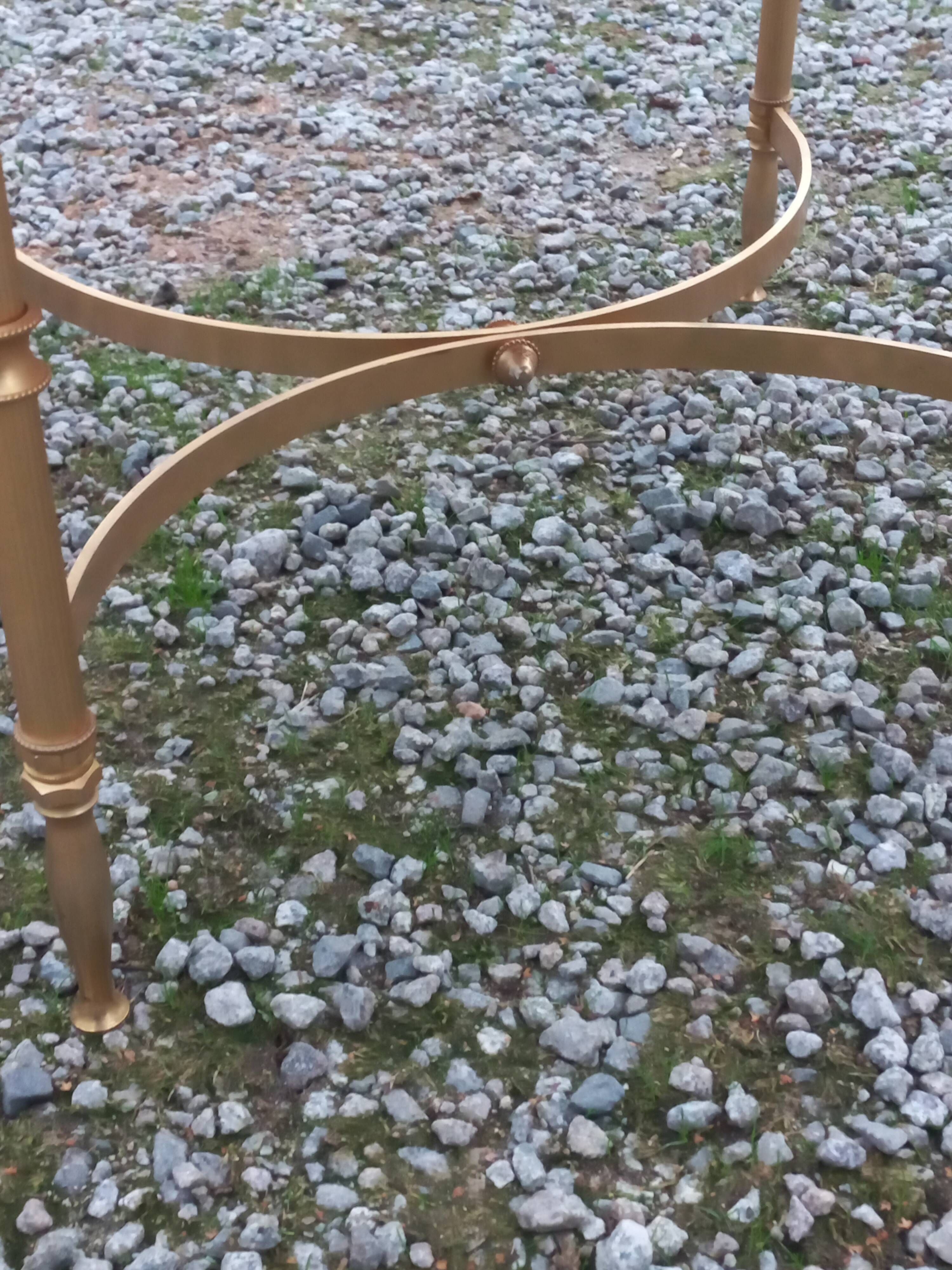 Round neoclassical coffee table with a marble top and golden metal base.