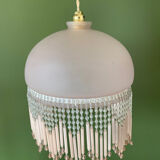 Globe pendant with pink tassels