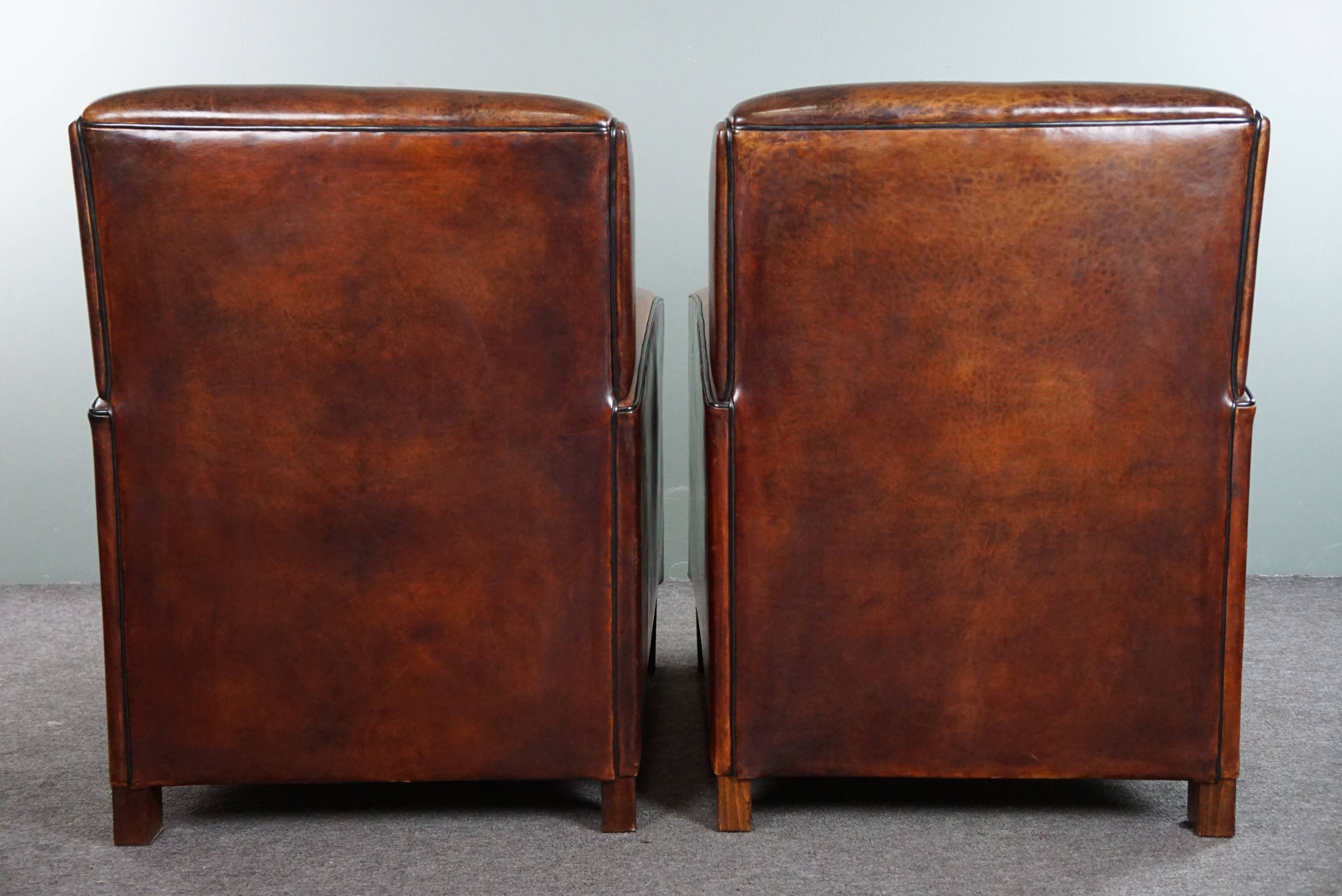 A very beautiful set of 2 Art Deco design armchairs in sheep leather