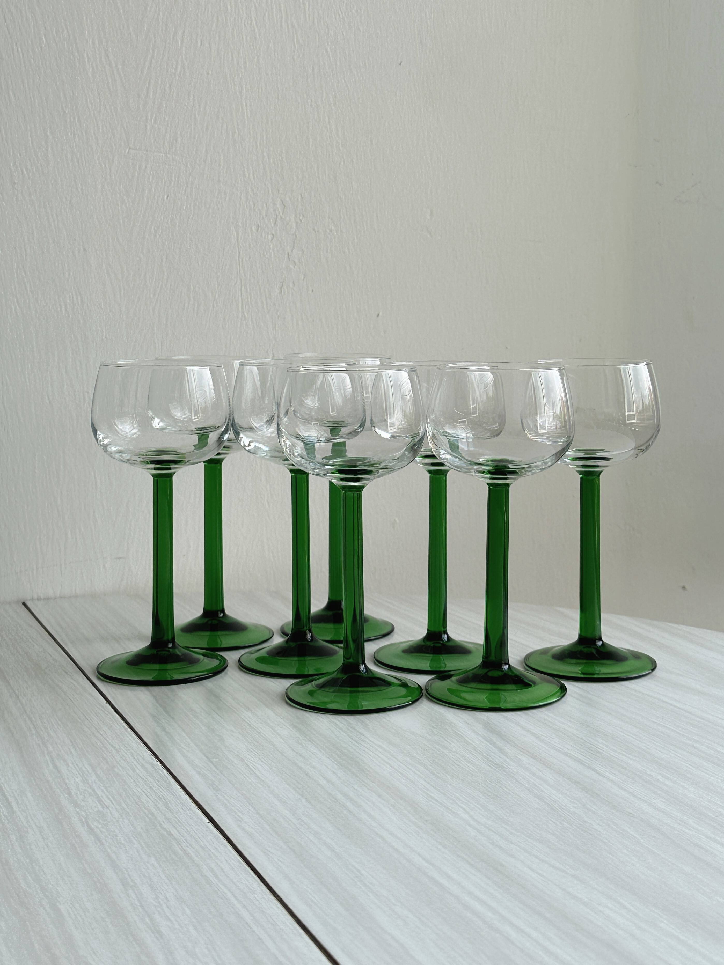 8 Alsatian stemmed glasses, transparent glass and green stems.