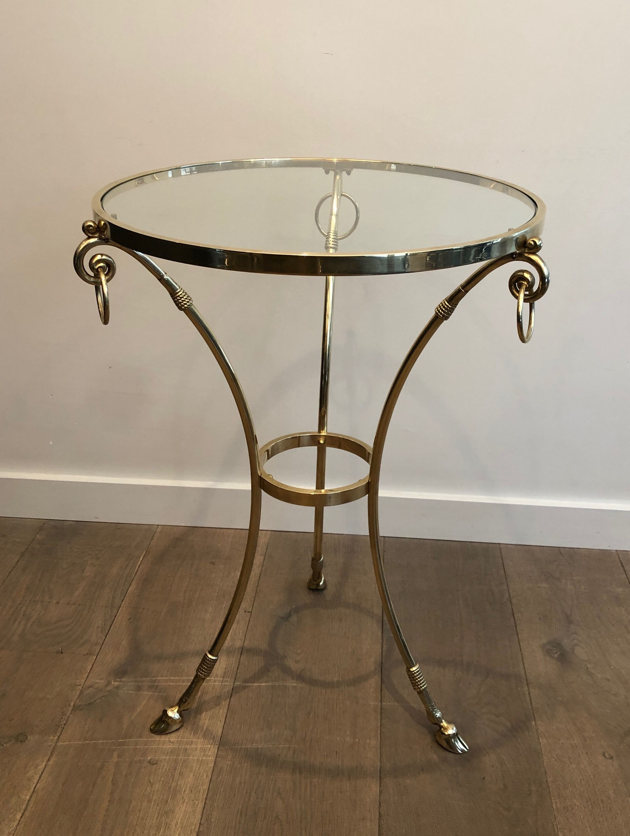 Neoclassical style tripod pedestal table in brass and round glass top in the taste of the House