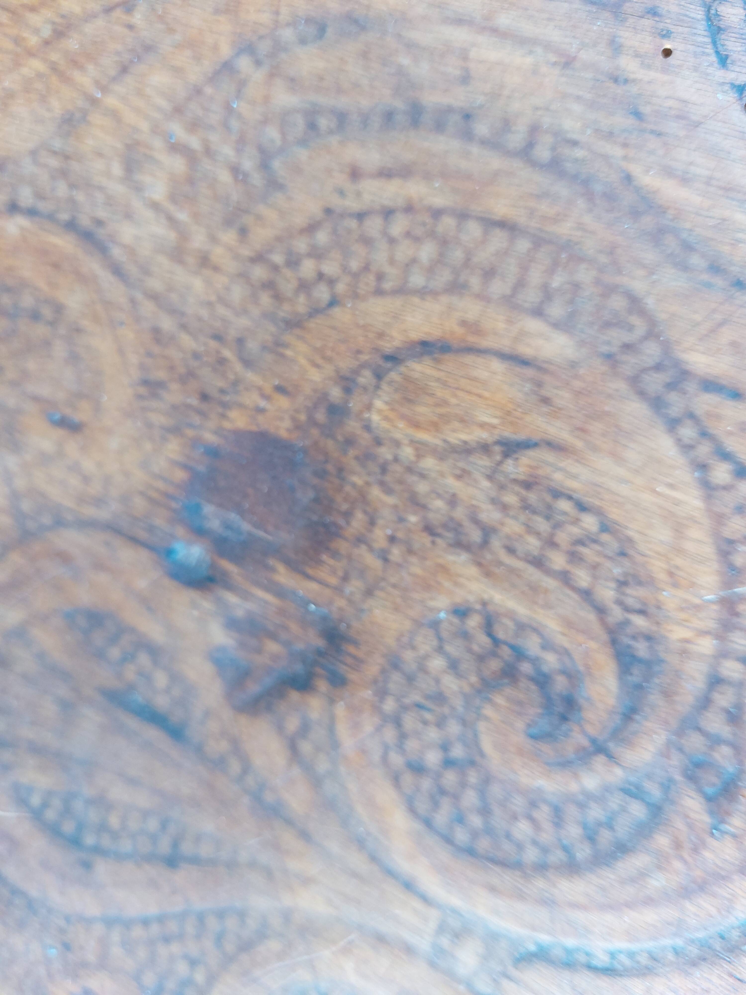 pair of round wooden chairs with a pattern on the seat