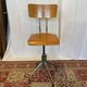 Old high workshop chair made of wood and metal.