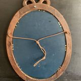 Antique oval mirror in carved wood and Louis XVI style knot