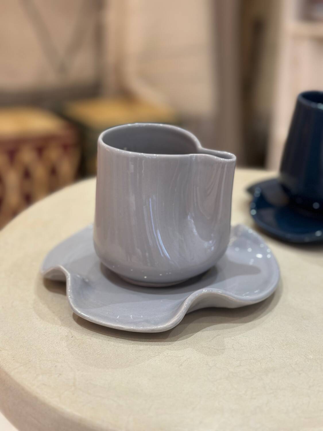 Set of ceramic artisan mugs with blue-grey pop water lily design.