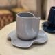 Set of ceramic artisan mugs with blue-grey pop water lily design.