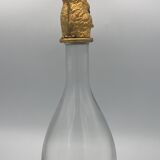 Glass bottle type carafe with gold metal bird head stopper