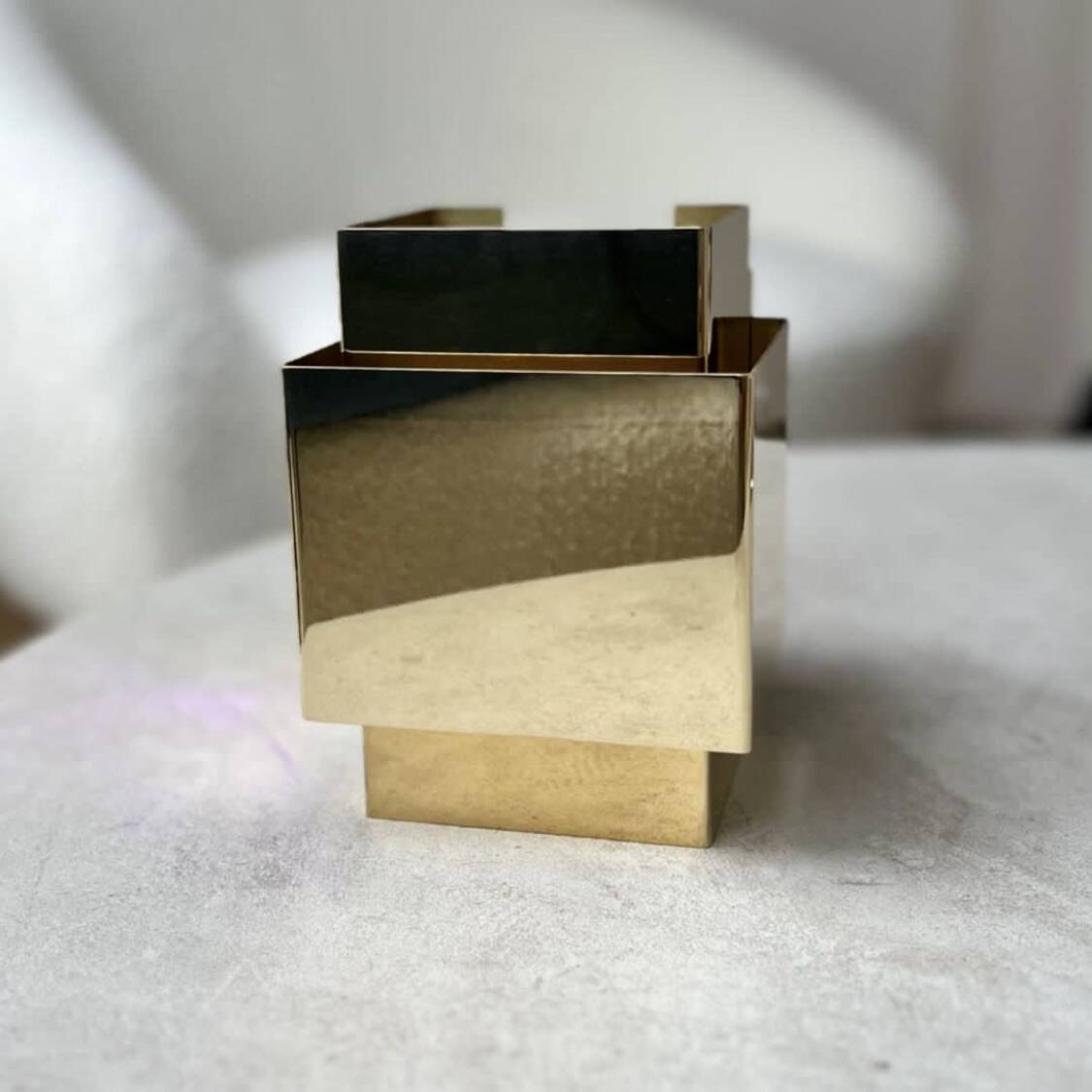 Cubical brass wall light