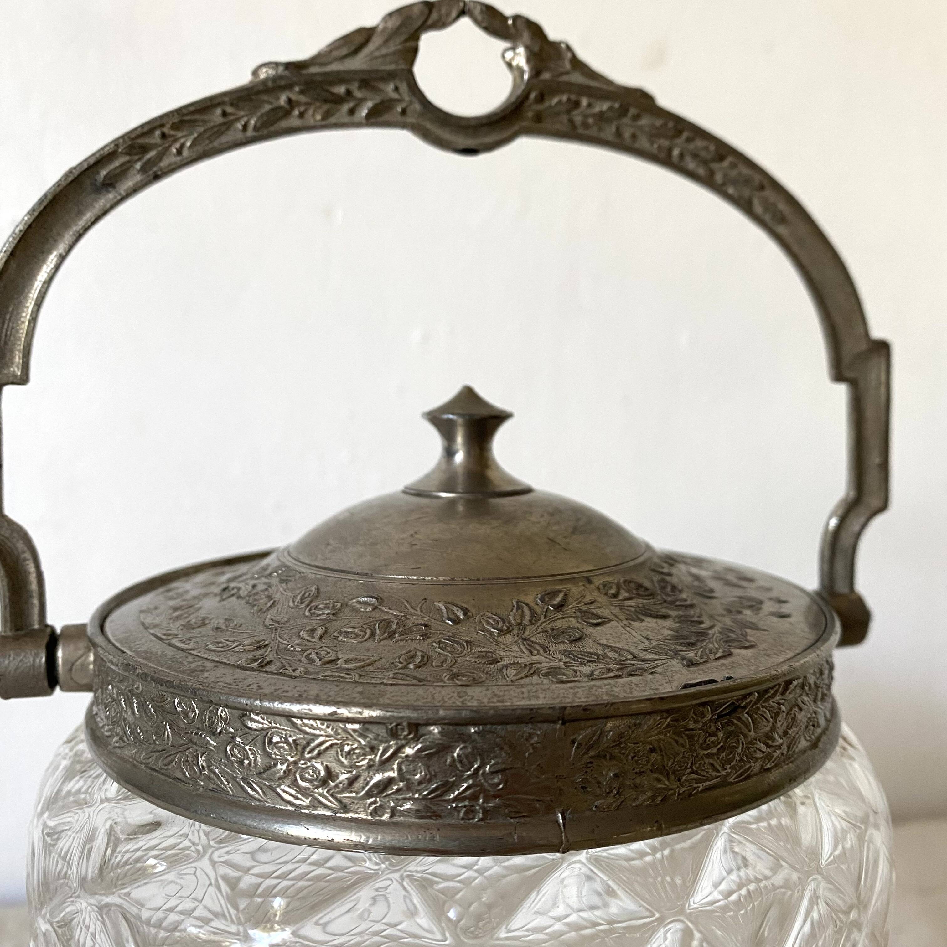 Old biscuit bucket in glass and metal