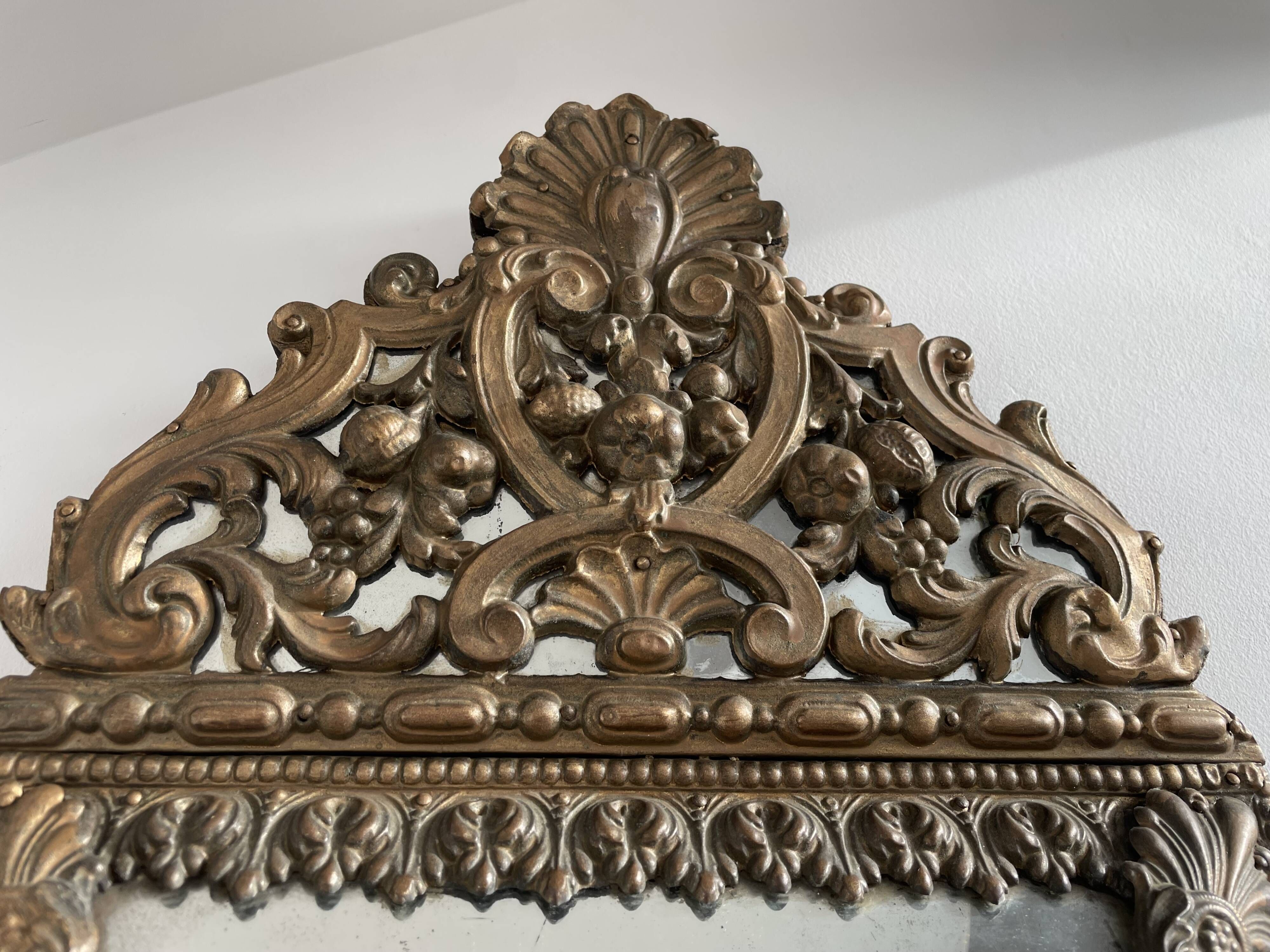 Small mirror with brass parcloses in repoussé style Louis XIV, late 19th century.