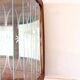 Art Deco-style wall-mounted display cabinet with floral engraving