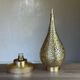 Handmade brass table lamp with a perforated drop-shaped shade.