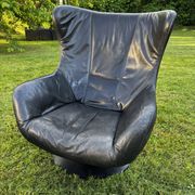 Egg chair style armchair and its ottoman.