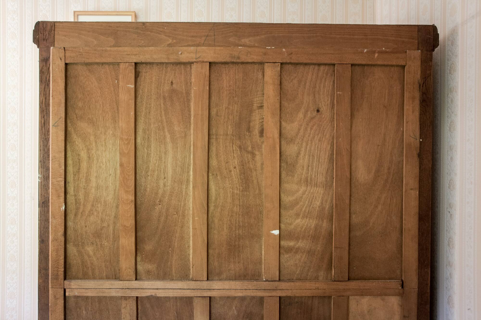 Old solid wood wardrobe with three vintage mirror doors