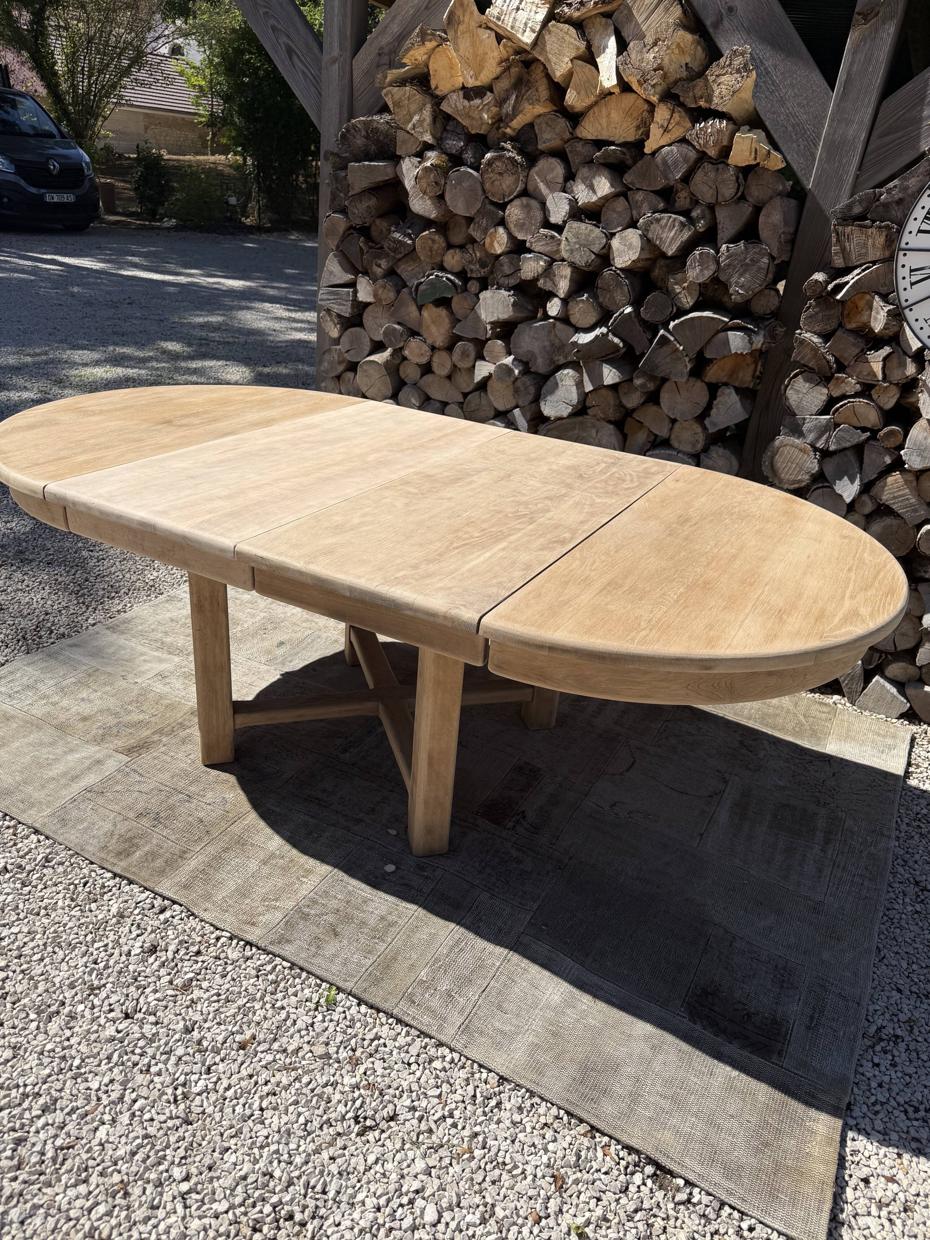 Round solid oak table with extensions, maximum 220cm.