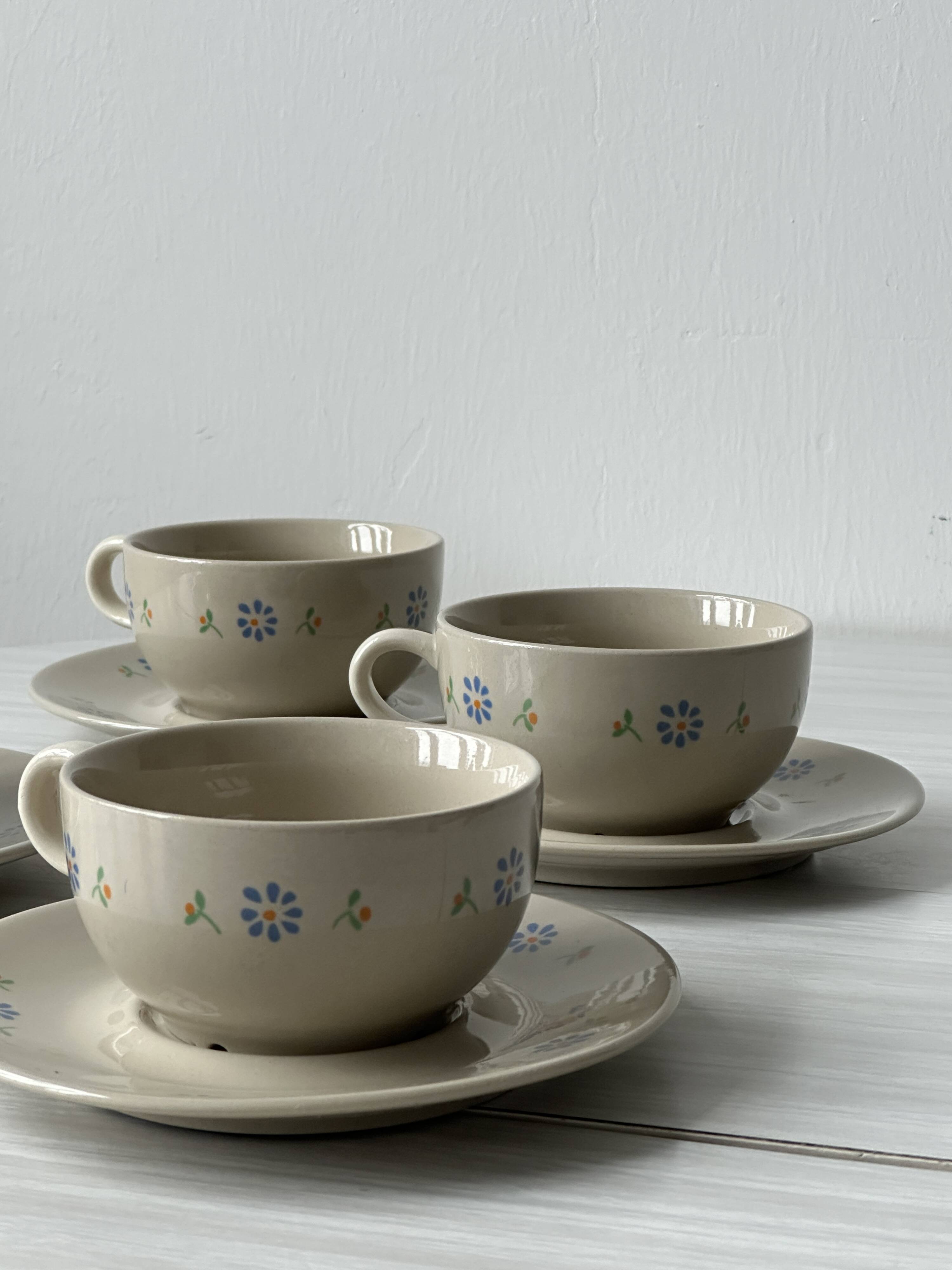 Ceramic cups and saucers with flower decoration