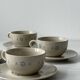 Ceramic cups and saucers with flower decoration