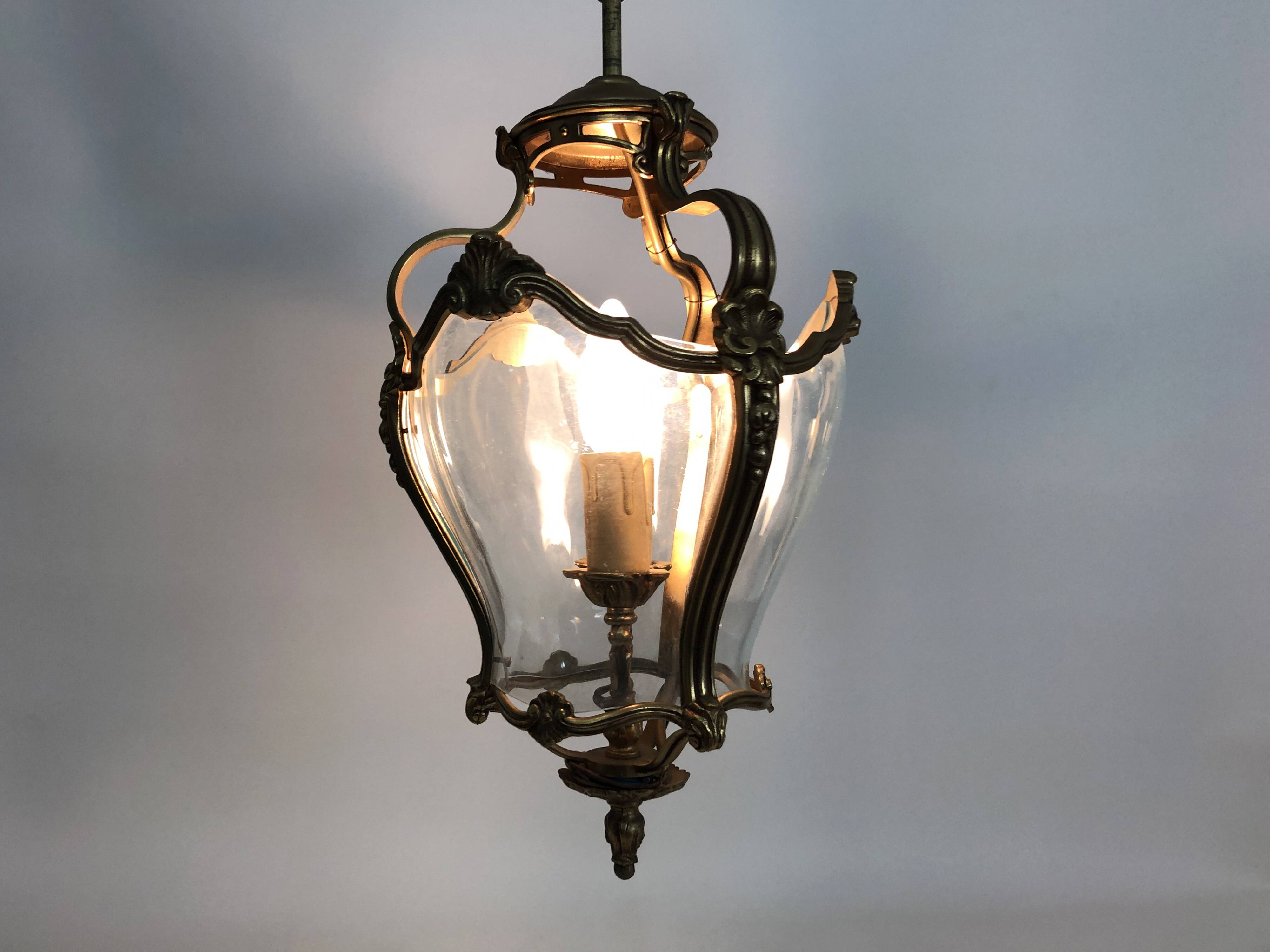 Old lantern with 3 faces, chandelier in gilded bronze and curved glass. Year 60