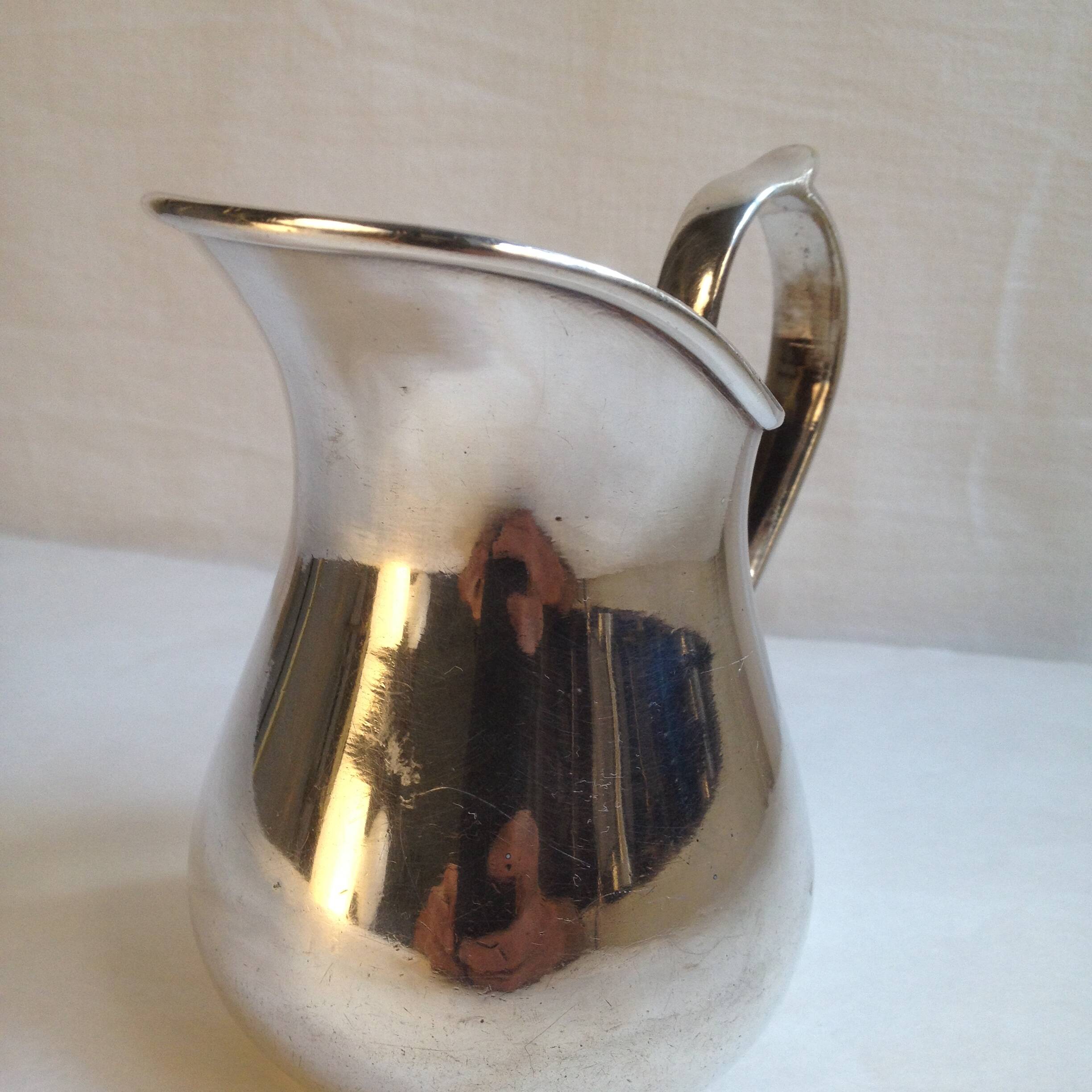 Silver metal milk jug
