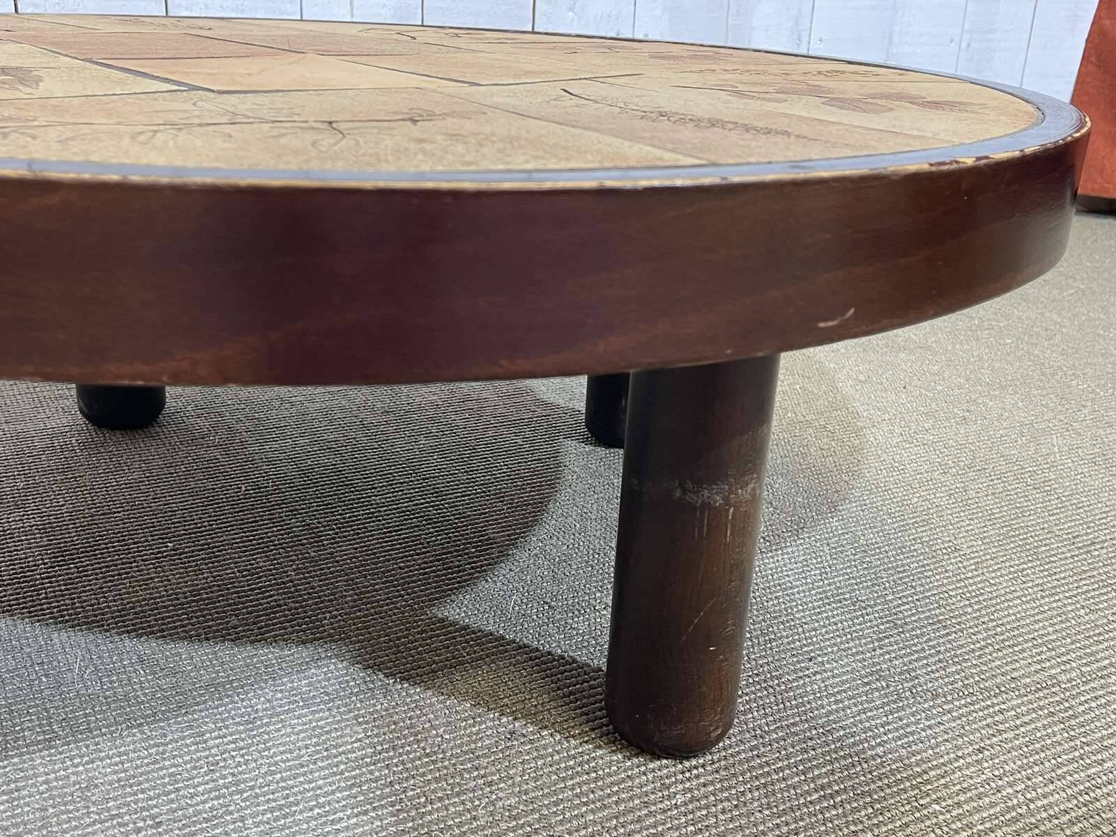 Beech coffee table with a ceramic top featuring a herbarium design.