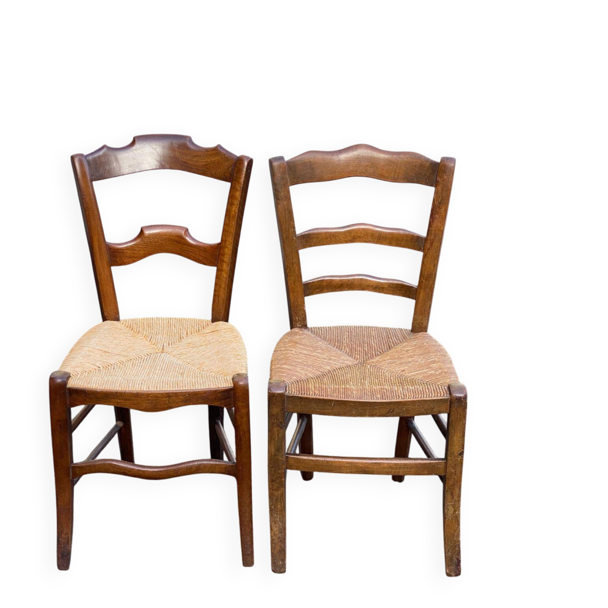 2 solid oak carved and rush-seated chairs in the Louis Philippe style, 19th century.