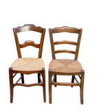 2 solid oak carved and rush-seated chairs in the Louis Philippe style, 19th century.