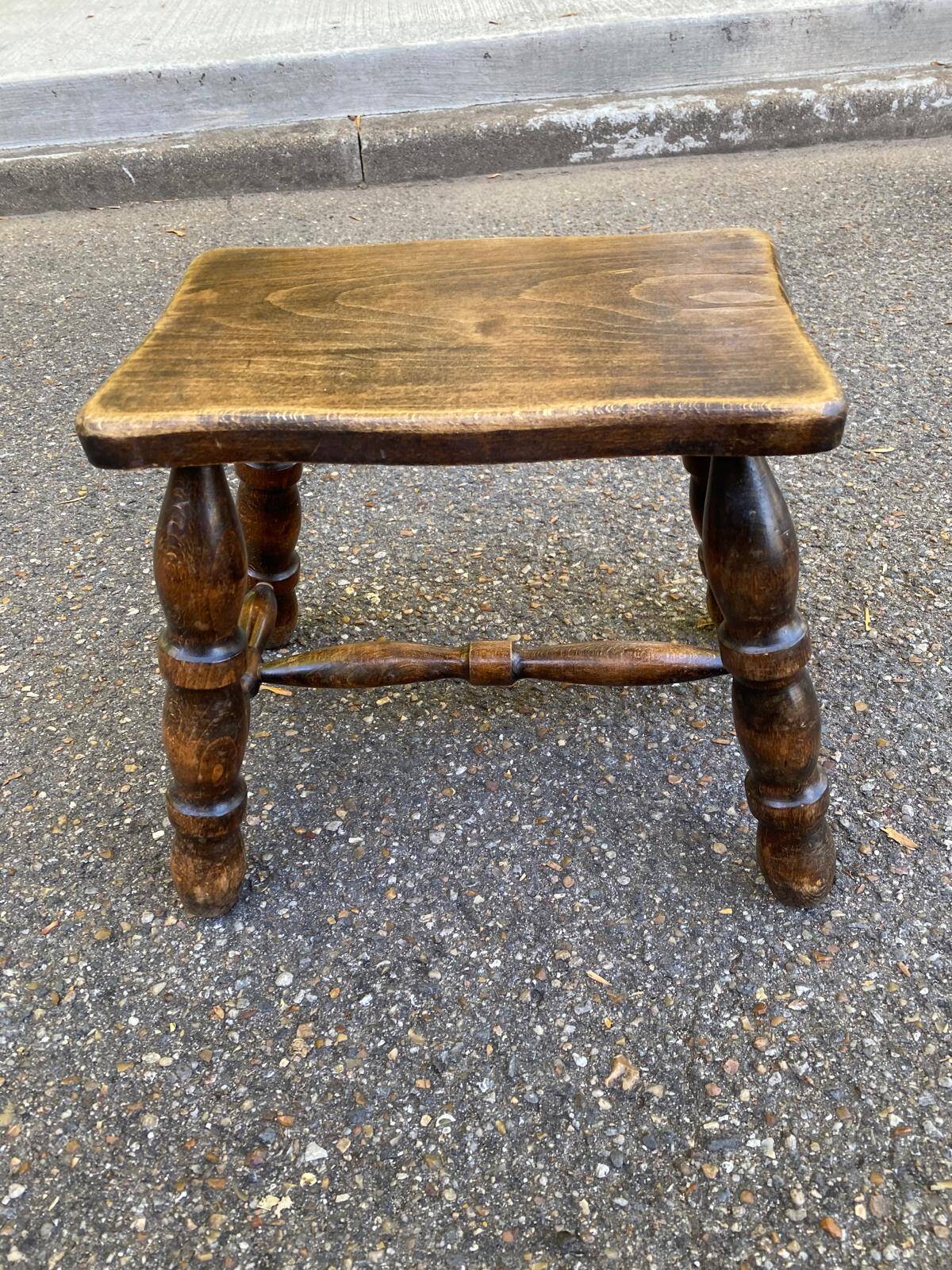 Small vintage low stool made of turned solid wood footrest 1960
